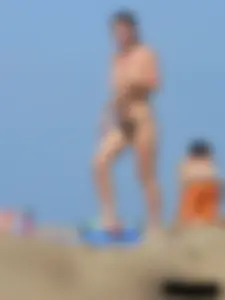 Sexy babe with a nice body topless and in a thong on the beach
