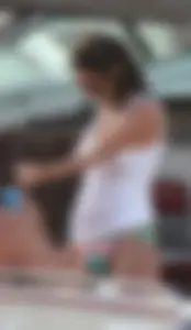 Bikini babe on a boat with a wet see through white shirt showing her tits