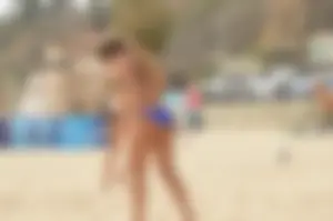 Sexy beach volleyball girl in sport bra top with pokies and blue bikini bottom