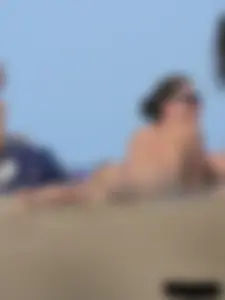 Sexy babe with a nice body topless and in a thong on the beach