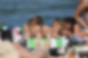A couple sexy girls laying out on the beach