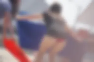 A group of teens in bikinis on the beach