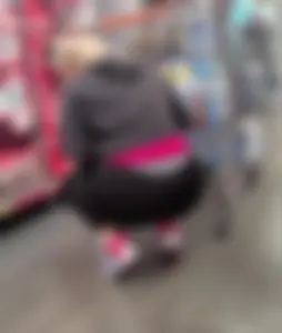 Candid thick Latina shopping in leggings squats down for the camera