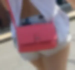 Sexy babe in short jeans shorts on the phone