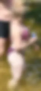Chunky blonde enjoying some drinks in the water in her purple bikini