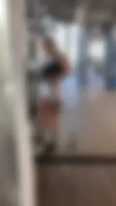 Hot blonde working out at the gym in shorts and crop top