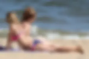 Two sexy beach teens in bikinis, one thick and one skinny with big boobs
