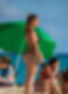 A few sexy girls with great asses in thong bikinis at the beach