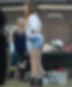 Hippie type dressed girl in denim shorts with a nice ass