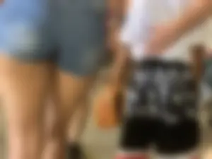 Bunch of girls in various outfits at a Cardinals baseball game