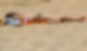 Thick girl on the beach with big boobs and a big booty