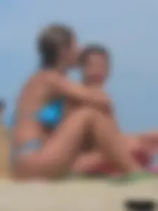 Sexy lady on the beach in a blue thong bikini