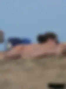 Sexy babe with a nice body topless and in a thong on the beach