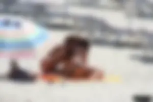 Topless milf and her topless daughter on the beach