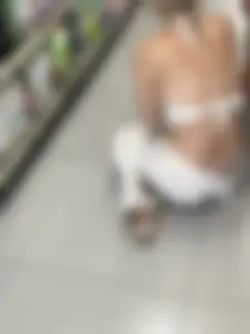 Blonde college girl squatting deep in supermarket, visible thong!