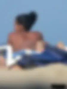 Hot ass topless beach girl with great tits lets her little brother oil up her ass in thong bikini