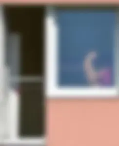 Peeping Tom pics of a topless girl in her house with nice tits