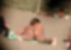 Topless girl on the beach showing some pussy lips in her little thong