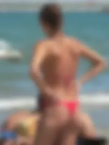 A bunch of hot babes on the beach in thong bikinis