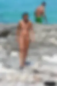 Older lady on a nude beach showing her body