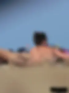 Sexy babe with a nice body topless and in a thong on the beach
