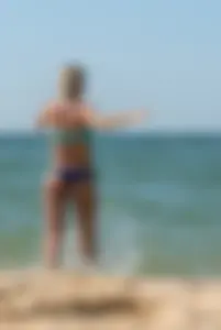 Sexy blonde milf on the beach in blue thong bikini and showing nice camel toe