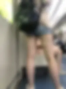 Tall Girl in Denim Mini Shorts and Sneakers With Long Pale Legs in a Subway Train