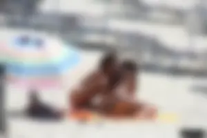 Topless milf and her topless daughter on the beach