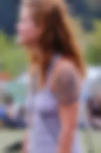 Cute hippie chick in tank top with no bra showing pokies