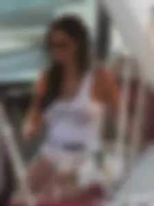 Bikini babe on a boat with a wet see through white shirt showing her tits