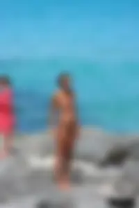 Older lady on a nude beach showing her body