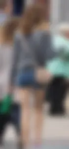 Smiling, slim and sexy in her shorts