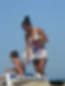 Hot ass topless beach girl with great tits lets her little brother oil up her ass in thong bikini