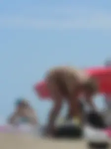 Sexy blonde on the beach in a yellow thong bikini