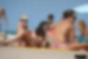 2 topless girls at the beach in thongs