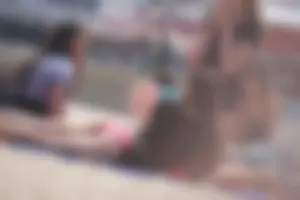A group of teens in bikinis on the beach