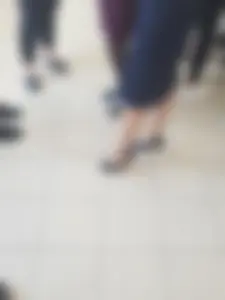 Legs of a Group of College Girls Standing in a Corridor