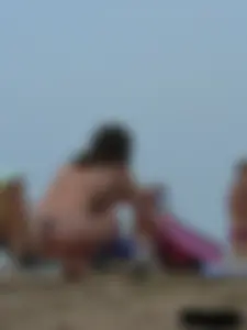 Sexy babe with a nice body topless and in a thong on the beach