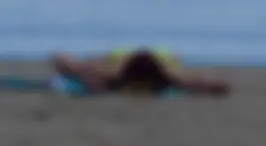 Sexy ass blonde milf on the beach in a thong with cameltoe and bending over