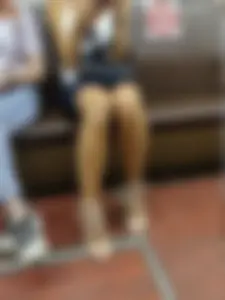Hot Legs of a Girl in a Skirt And Sandals Sitting in a Subway Train
