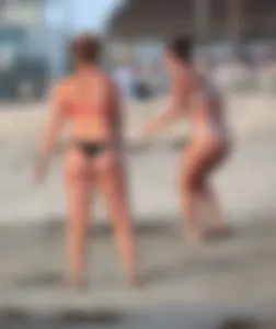 Thick white girls ass in a black thong bikini at the beach