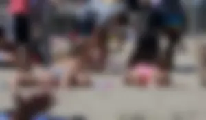 Sexy brunette on the beach in a bikini with great tits