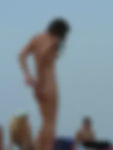 Sexy babe with a nice body topless and in a thong on the beach