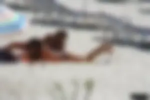 Topless milf and her topless daughter on the beach