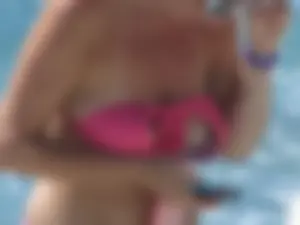 Mature milf's tits flashing in the pool
