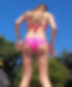 Sexy blonde up close in pink bikini with friend