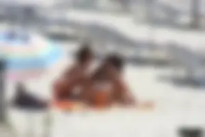 Topless milf and her topless daughter on the beach