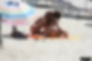 Topless milf and her topless daughter on the beach