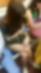 Cute Girl Sitting Cross-Legged in the Subway Train