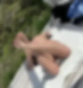 Awesome candid milf in a swimsuit sunbathing